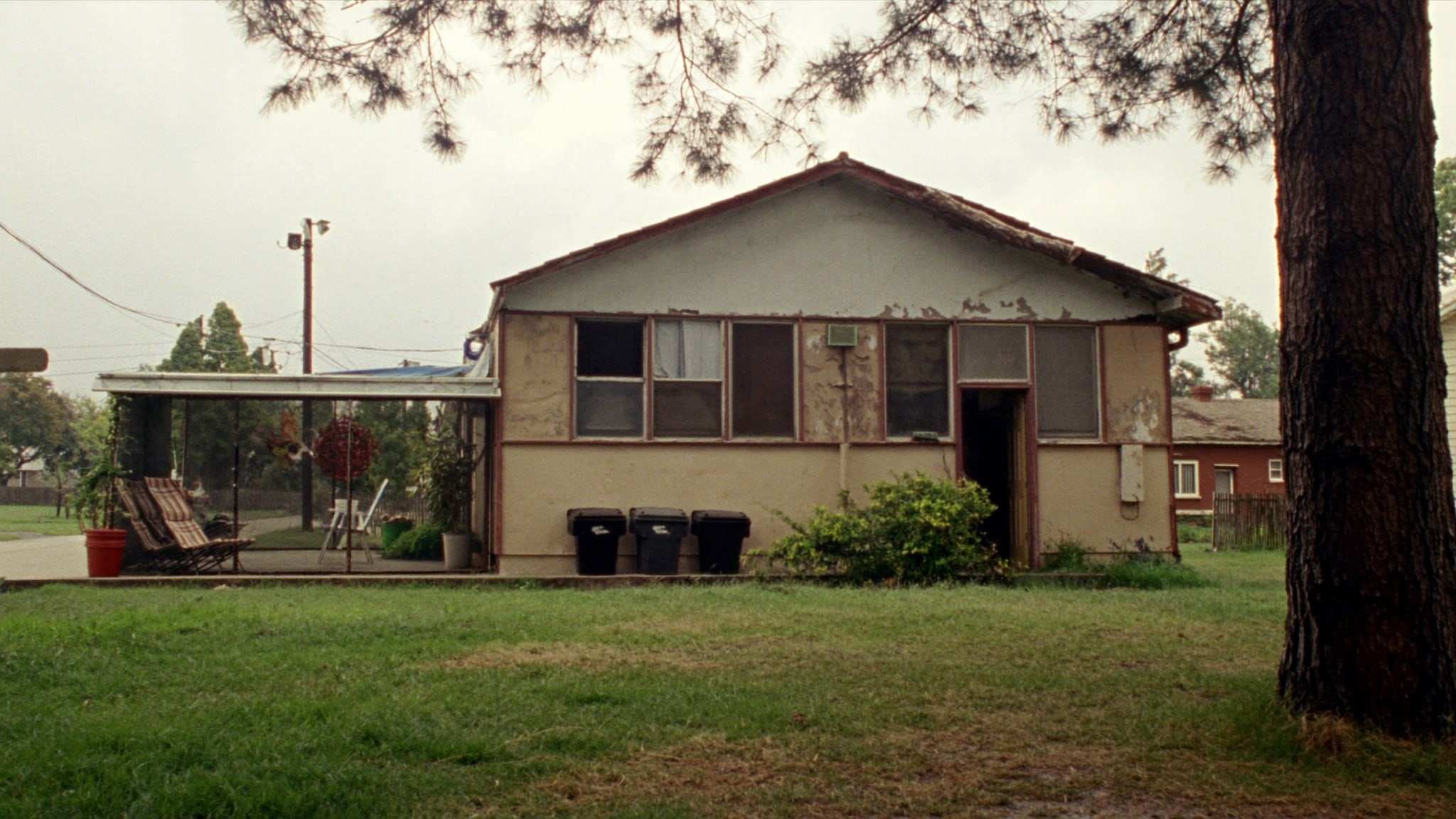 Older house with worn siding and a tired roof
